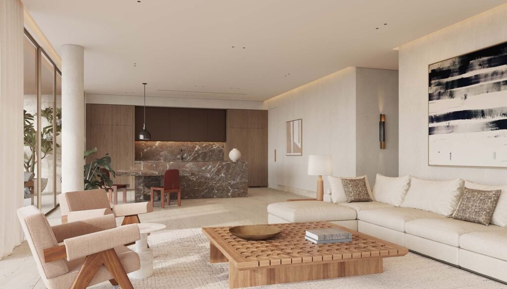 Contemporary open-plan living and kitchen area with large white sectional sofa, custom wooden coffee table, and dark marble kitchen island in Eden Hills Dubai.