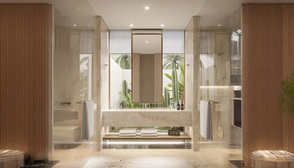 High-end master bathroom interior featuring marble walls, stone vanity, and a window view of a private tropical outdoor garden with cacti in Eden Hills Dubai.